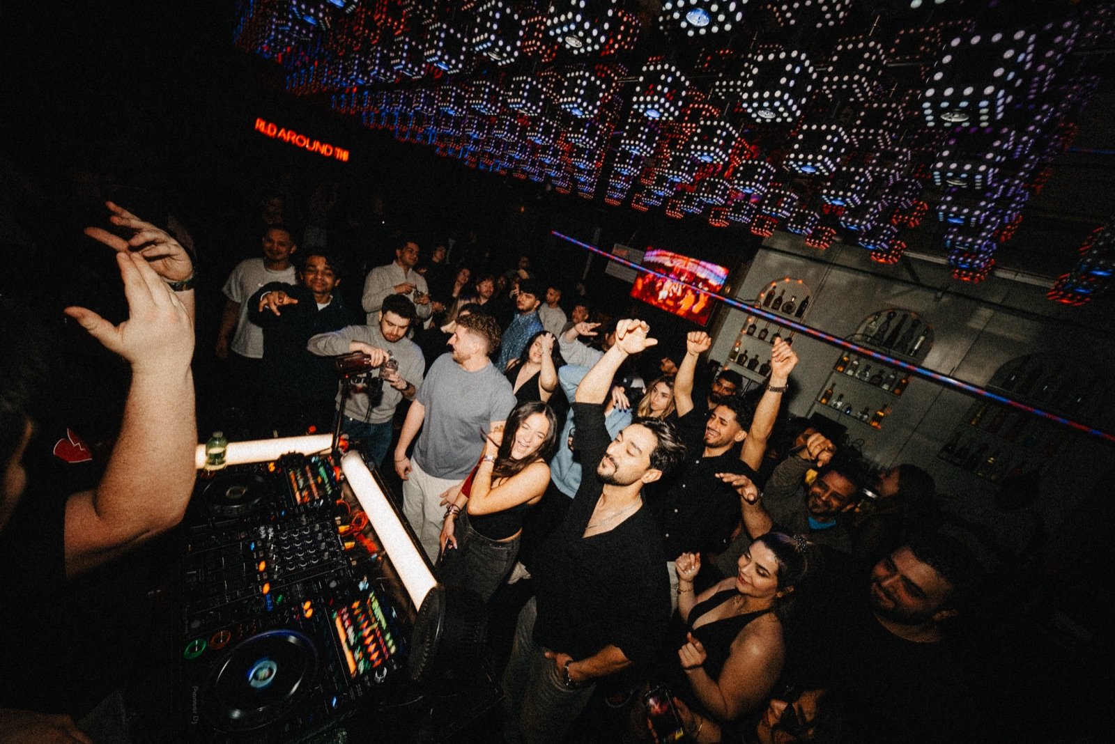 View from the DJ booth as the crowd dances under the lights