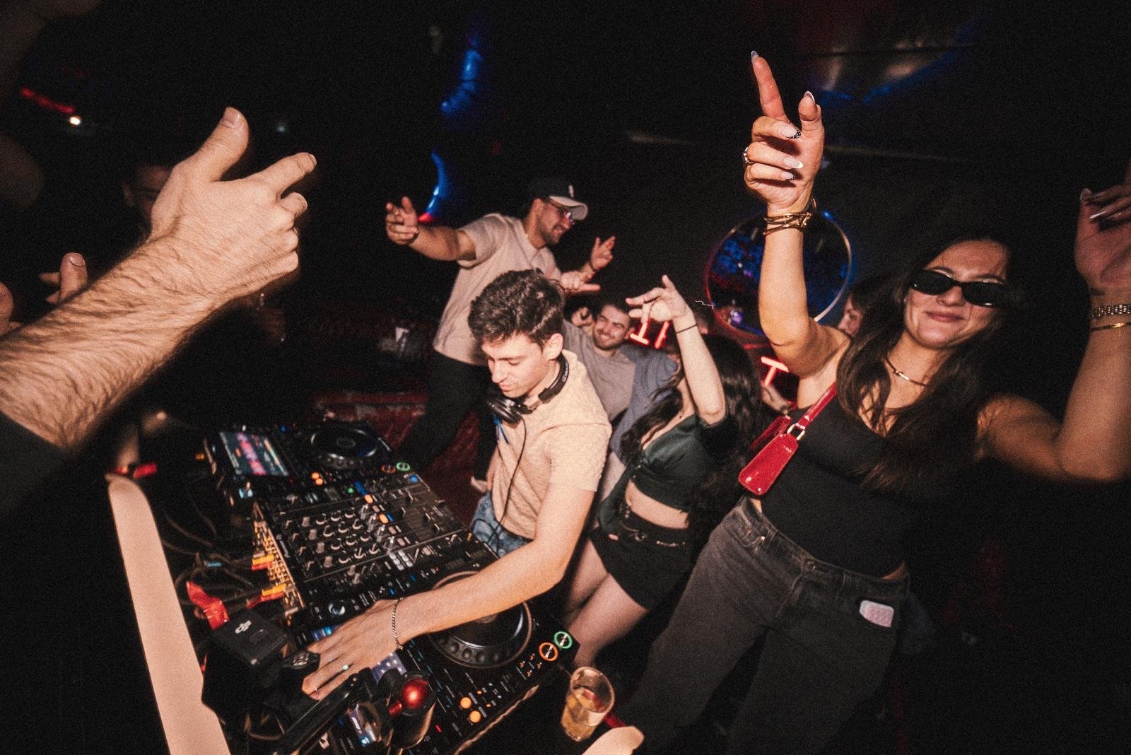 TALMOR mixing at the decks as the crowd dances